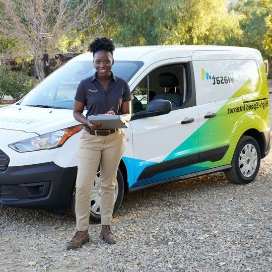 Viasat technician next to viasat van